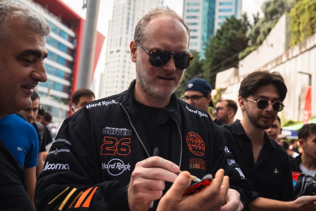 Maximillion Cooper with Gumball 3000 hypercars in Istanbul at the Cars on Sundays event, featuring Ferrari, Lamborghini, and Mercedes supercars.